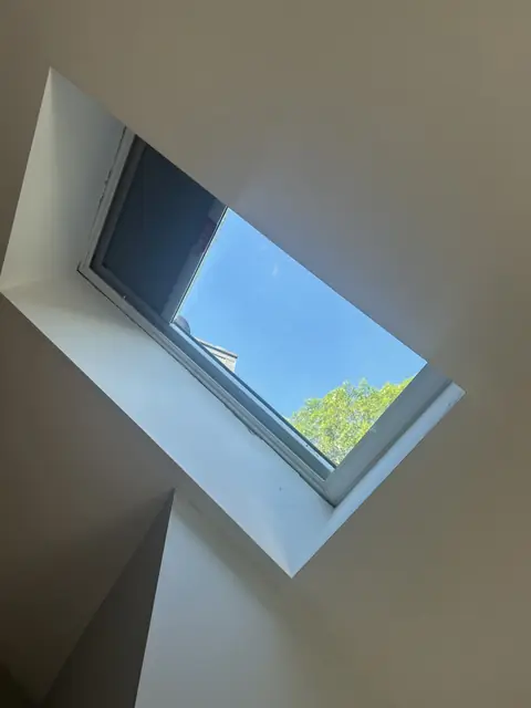 Interior skylight shaft in a sloped ceiling before the skylight was replaced